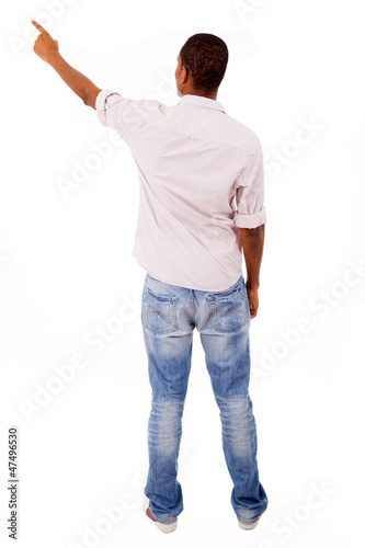 Young casual man pointing, isolated on white