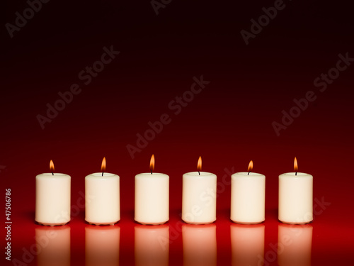 row of white burning candles