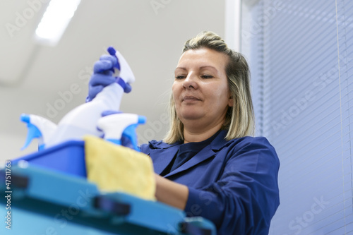 Woman working as professional cleaner in office