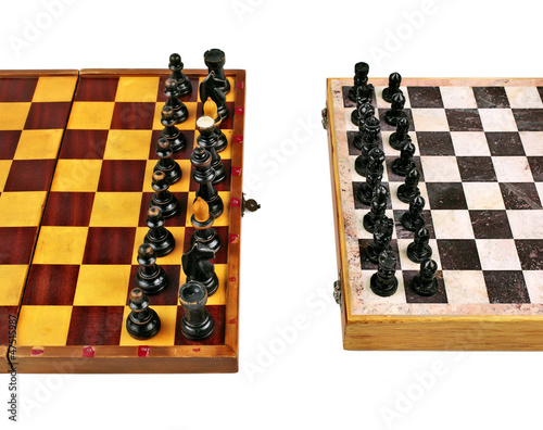 Two Old Chessboards with Figurines in Confilct photo