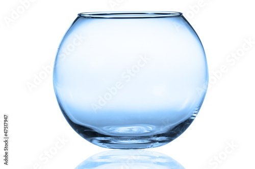 Empty fishbowl without water in front of white background.