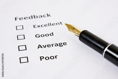 Feedback/Rating sheet with Fountain pen on white background