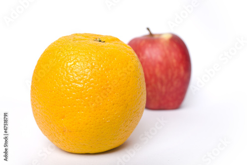 Comparing apples verses oranges on a white background