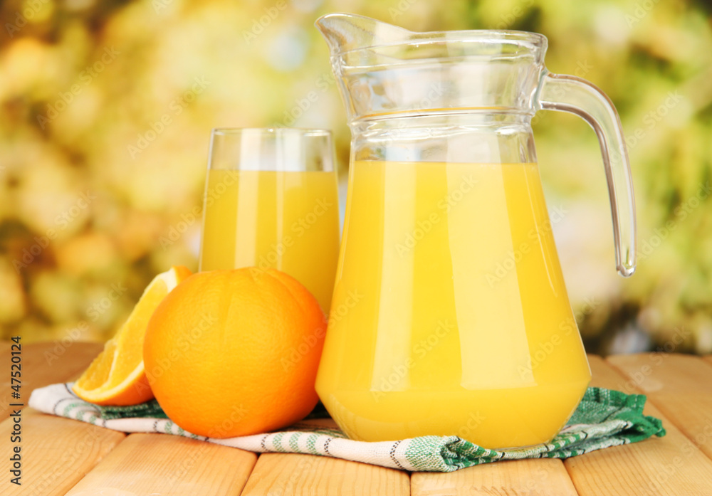 Full glass and jug of orange juice and oranges Full glass and jug of orange juice and oranges