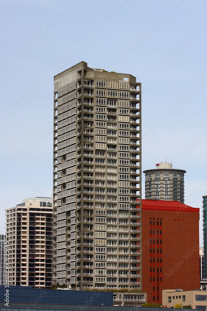 Fototapeta premium Grey Condo Tower by Red Brick