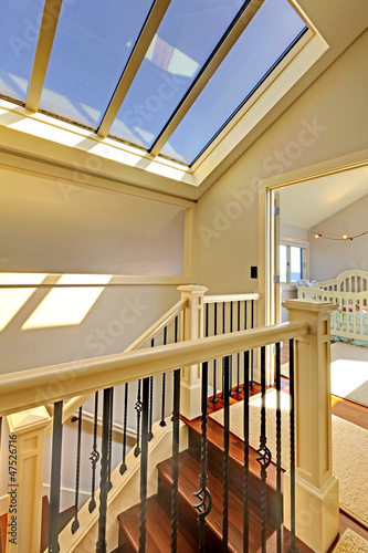 Staircase with skylight and baby room.