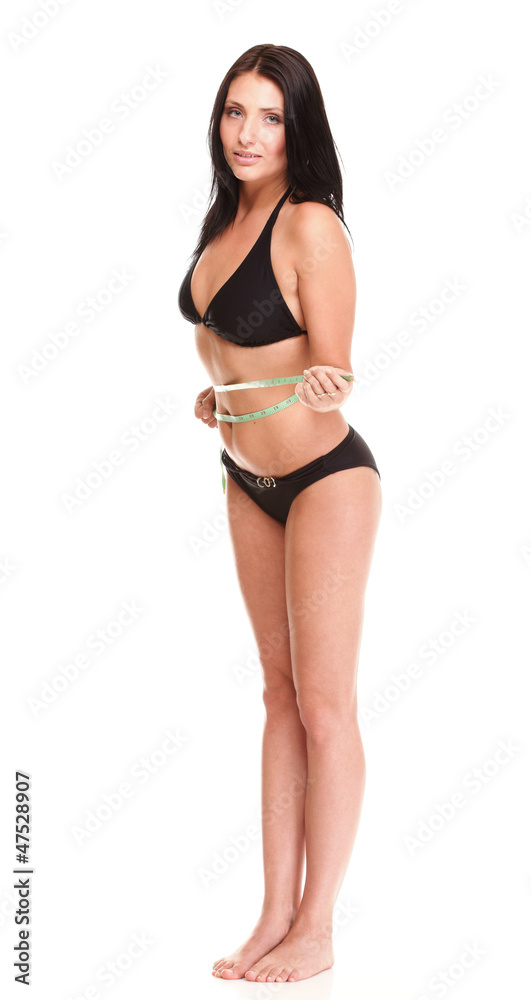 brunette girl bikini measuring waistline tape