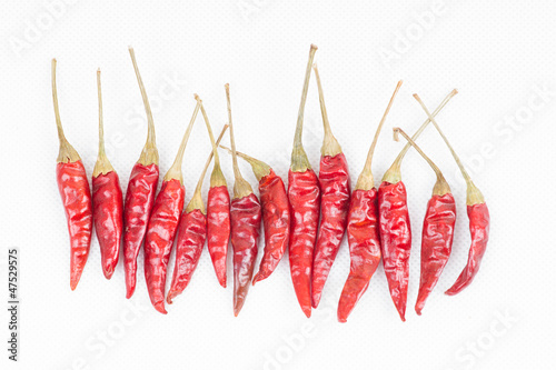 row of red peppers on white background