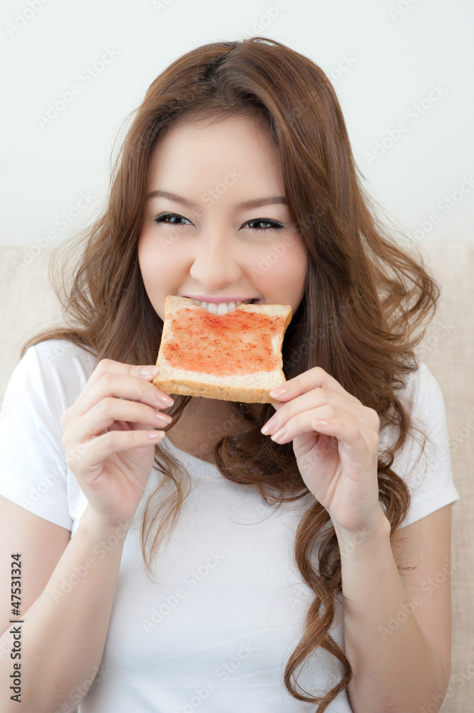 Happy Young Woman Eating Bread and jam Happy Young Woman Eating Bread and jam