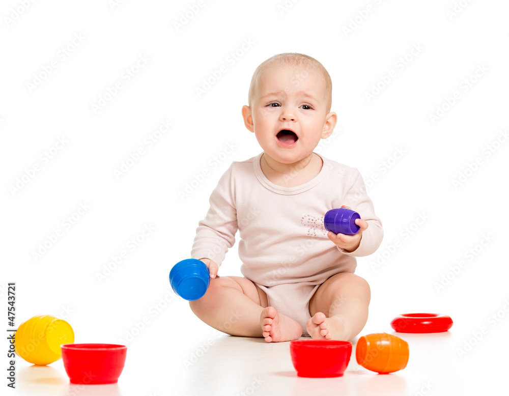 Funny little child is playing with toys while sitting on floor, Funny little child is playing with toys while sitting on floor,