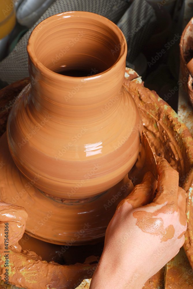 hands of a potter, creating an earthen jar on the circle hands of a potter, creating an earthen jar on the circle
