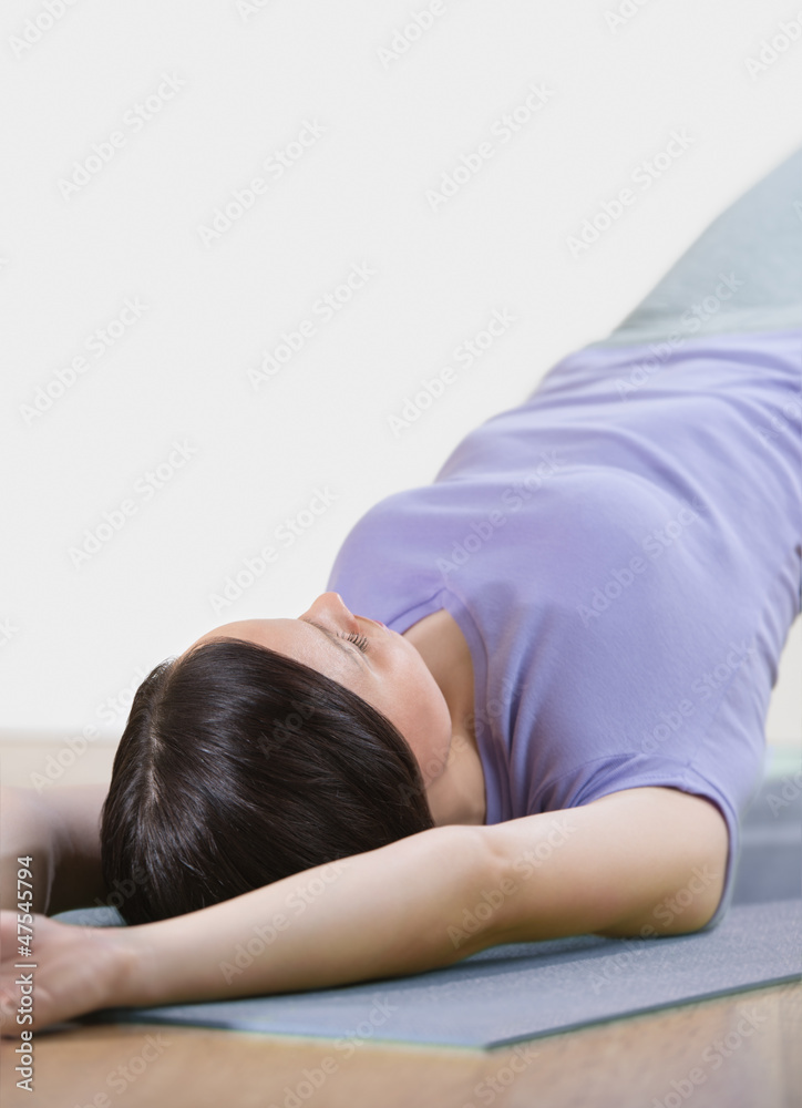 Portrait of healthy young woman practising yoga exercise on mat Portrait of healthy young woman practising yoga exercise on mat