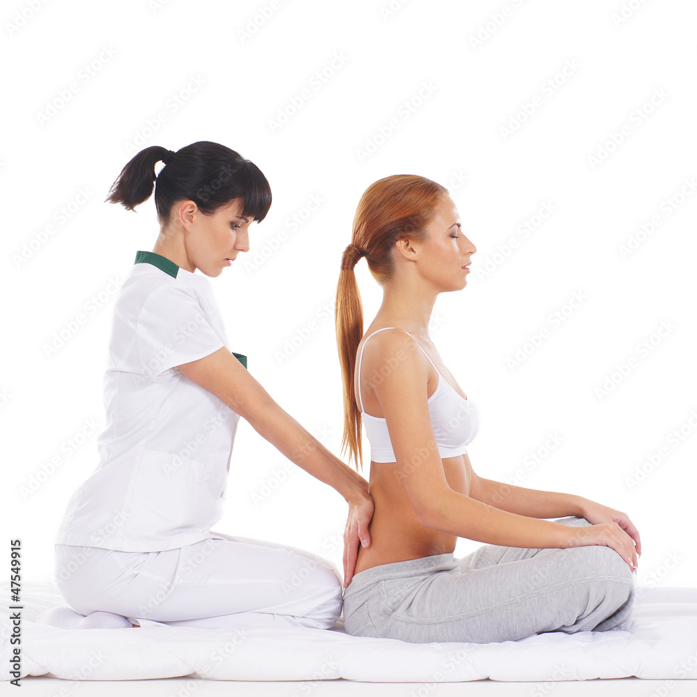 A young redhead woman getting a traditional Thai massage A young redhead woman getting a traditional Thai massage