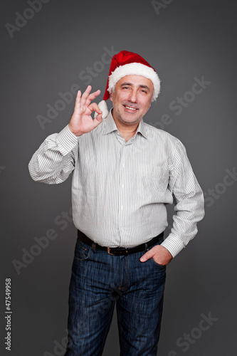 man in santa claus hat showing ok sign