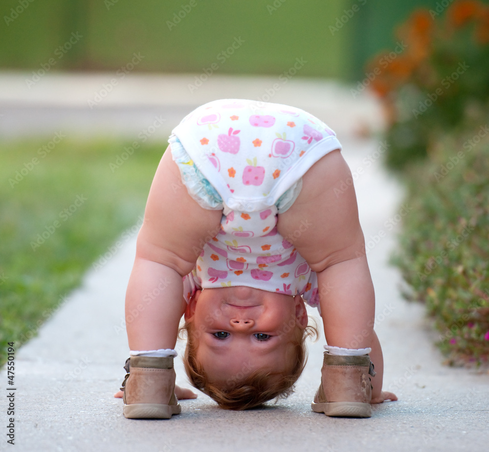 Baby is just playing on the street