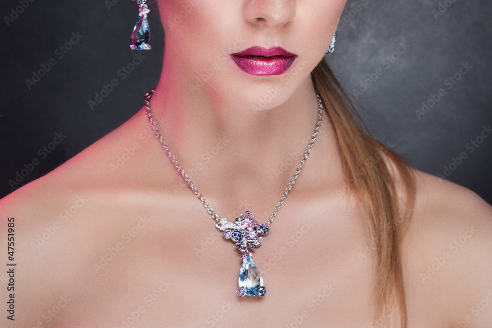 Woman posing in exclusive jewelry. Professional makeup