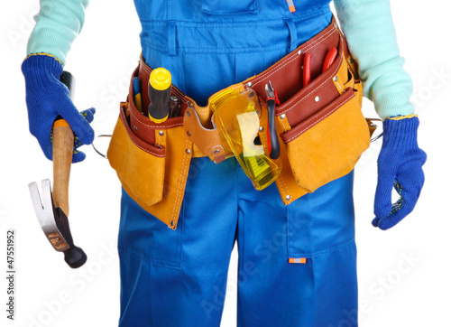 Male builder in blue overalls with gavel isolated on white