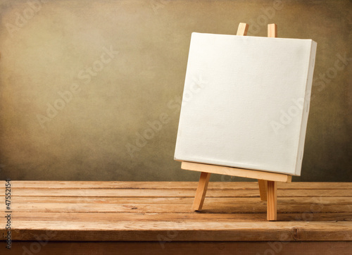 Background with blank canvas on wooden table