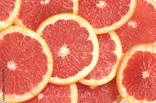 fresh grapefruit and slices on white background