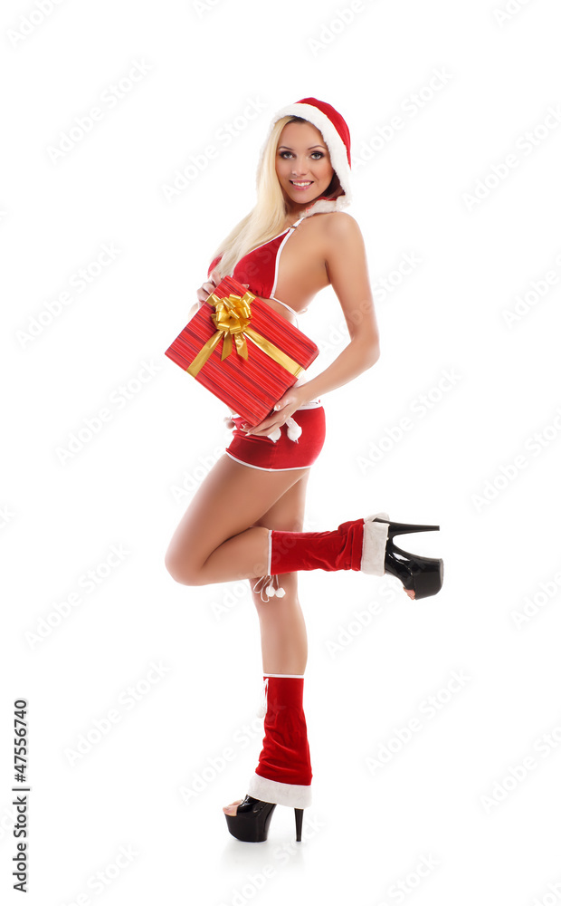A young woman in erotic Christmas clothes holding a present A young woman in erotic Christmas clothes holding a present