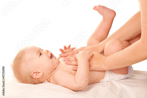 Baby massage. Mother massaging kid belly, baby laughing.