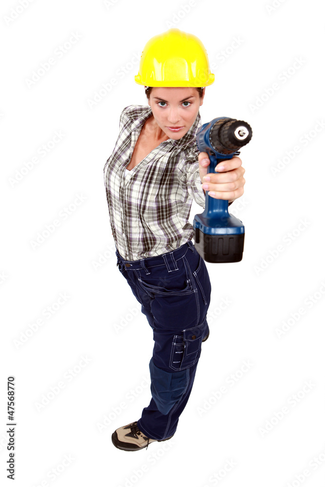 A female construction worker using a drill as a gun. A female construction worker using a drill as a gun.