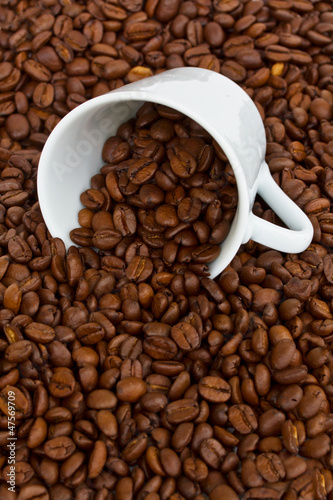 cup with raw coffee beans