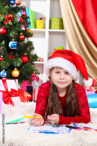 Beautiful little girl write...