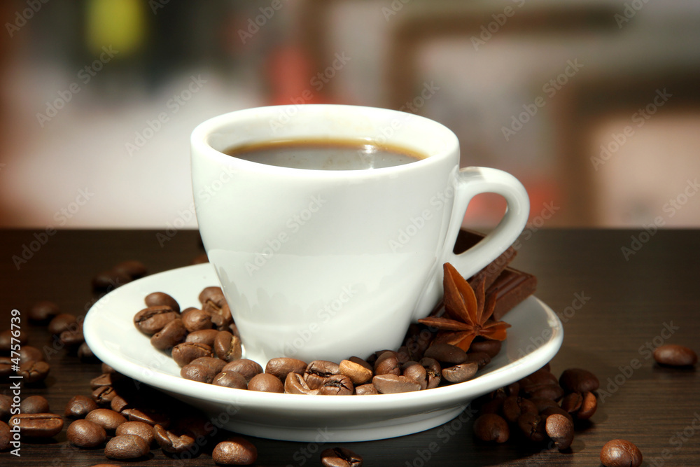 cup of coffee with beans on table in cafe cup of coffee with beans on table in cafe