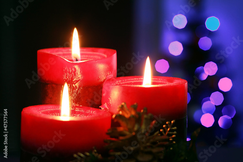 Christmas candles with blurry lights on background