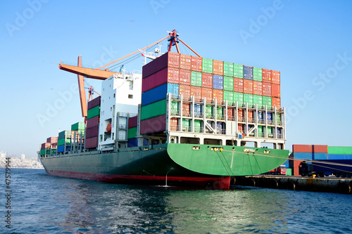 Green cargo ship in seaport