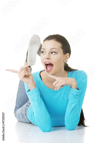 Happy   excited young woman pointing on copy space