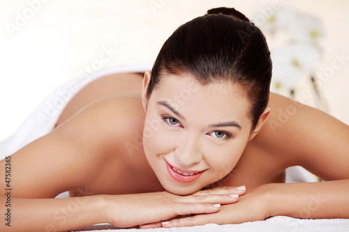 Young woman relaxing in spa saloon