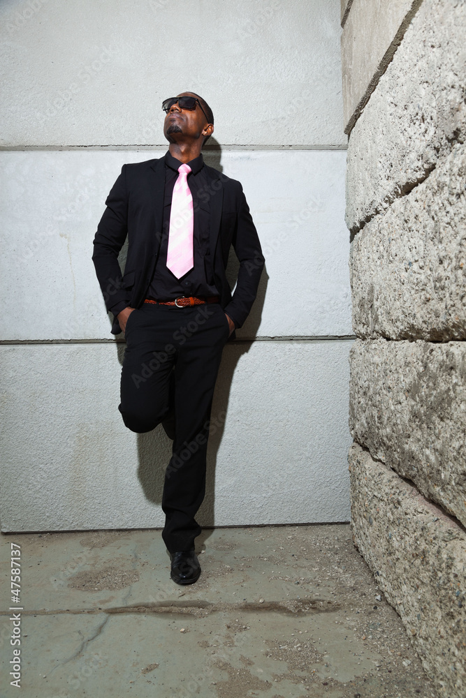 Cool black american man in dark suit wearing sunglasses. Cool black american man in dark suit wearing sunglasses.