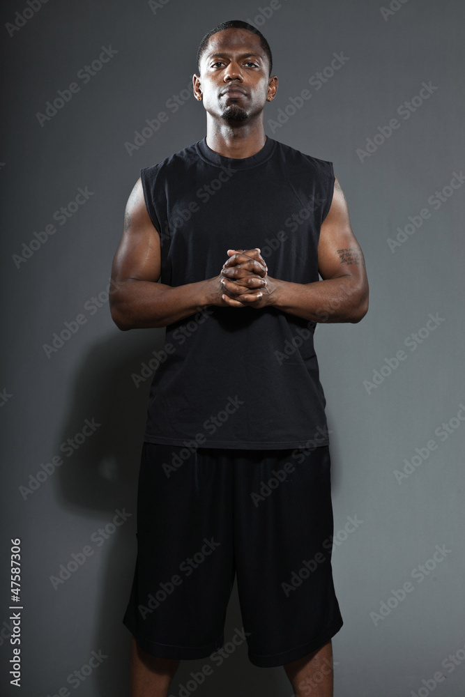Tough and cool black american basketball player. Studio shot.