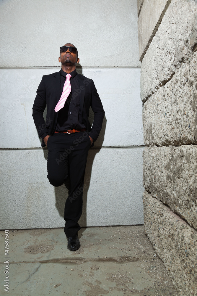 Cool black american man in dark suit wearing sunglasses. Cool black american man in dark suit wearing sunglasses.