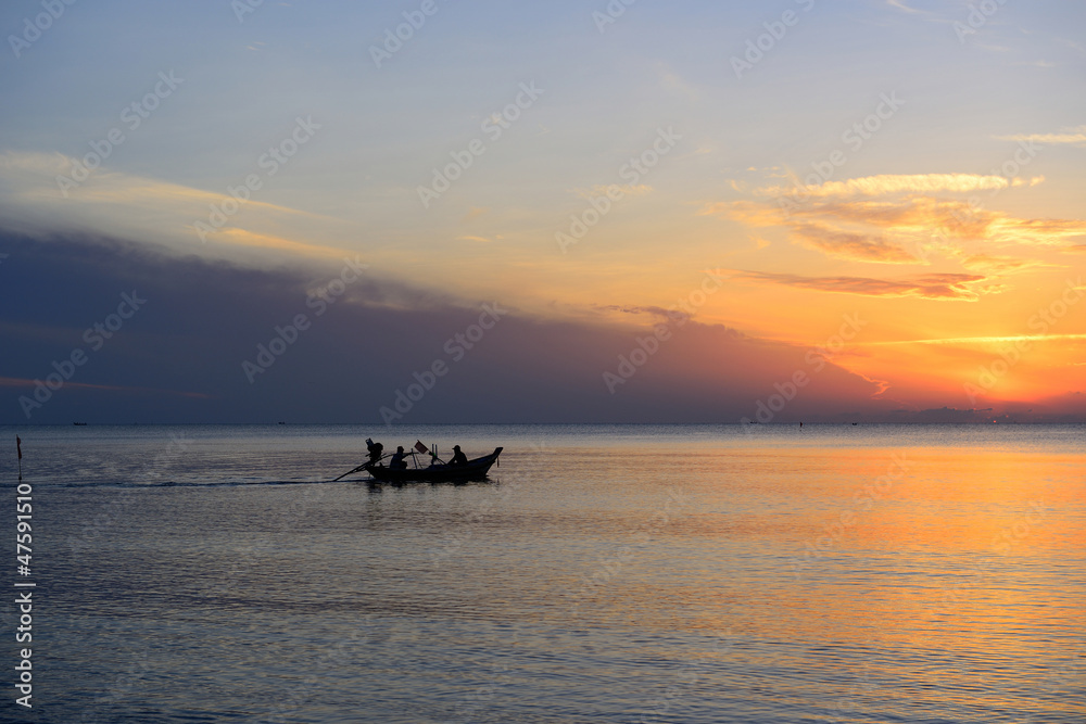Silhouette fisherman are taking fishing boat
