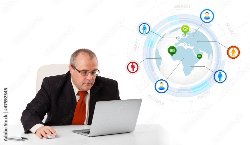 businessman sitting at desk and looking laptop with globe and so businessman sitting at desk and looking laptop with globe and so