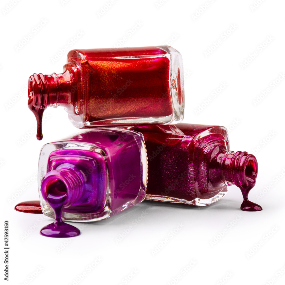 Bottles with spilled nail polish over white background Bottles with spilled nail polish over white background