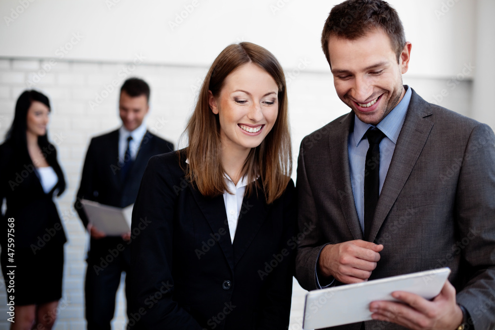 Two Happy business people working with digital tablet Two Happy business people working with digital tablet