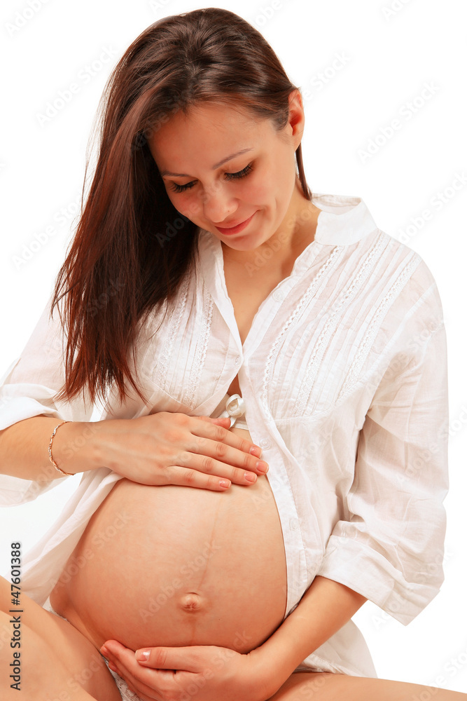 Pregnant woman with hands over tummy Pregnant woman with hands over tummy