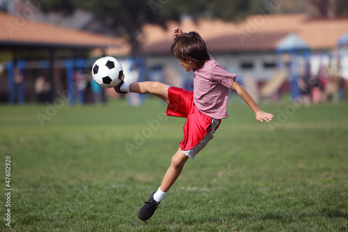 Boy playing soccer in the park © Nicholas B