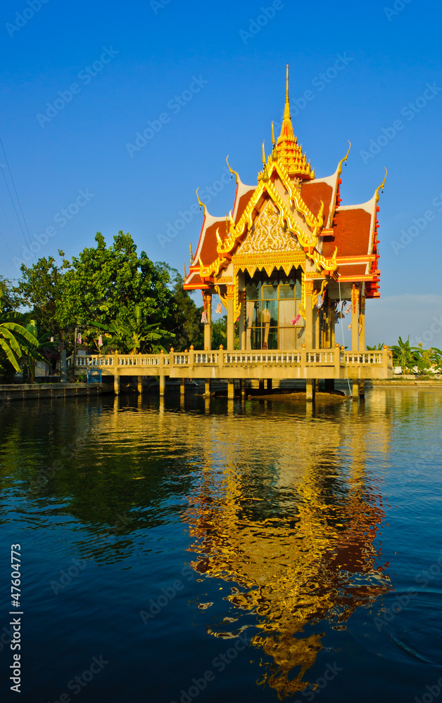 Thai temple pavilion with reflection