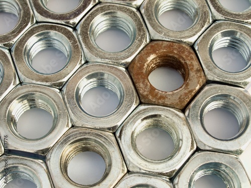 Metal nuts arranged in a plane