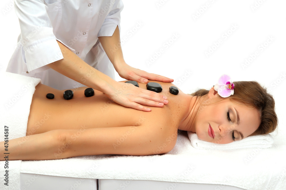 Fototapeta premium beautiful woman in spa salon with spa stones getting massage,