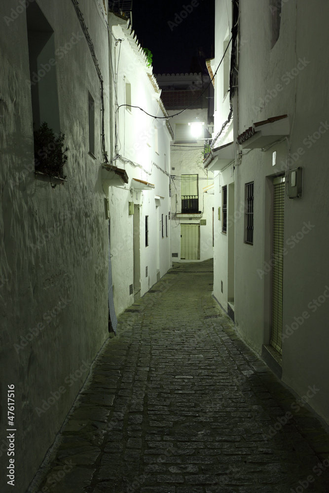 Narrow street in Andalusian village Casares at night, Spain
