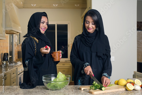 Two Arabian Women Cooking & Drinking coffee in the Kitchen