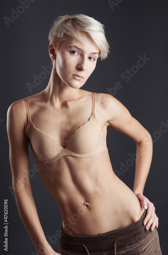 Young woman in lingerie isolated against dark background. 