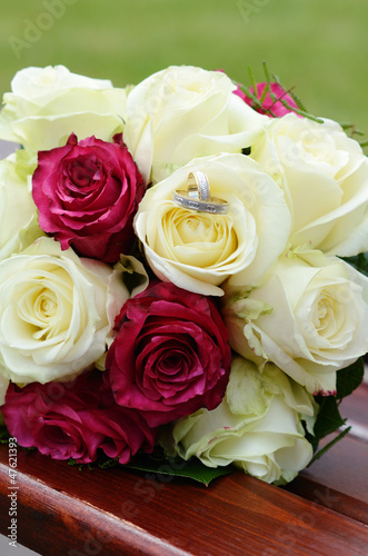Wedding bouquet of roses with golden rings