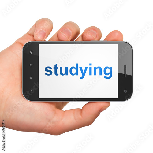 Hand holding smartphone with word studying on display. Generic m